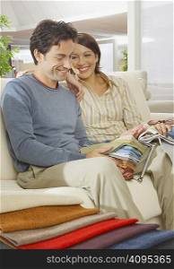 Couple sitting on sofa in furniture shop