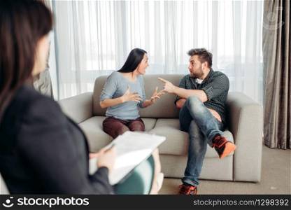 Couple sitting on sofa, psychologist reception, civilized solution to the problem. Female doctor helps patients with consultation, family psychology support. Couple sitting on sofa, psychologist reception