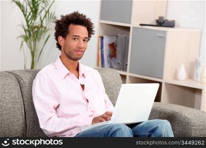 Couple sitting on sofa with computer