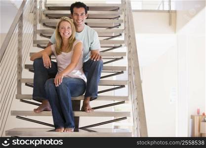 Couple sitting on staircase smiling