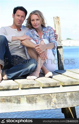 Couple sitting on the pier