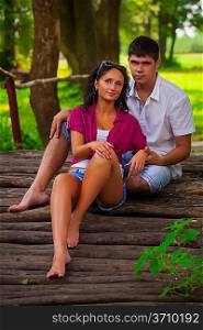 couple sitting on wooden logs