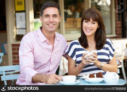 Couple sitting outside cafe
