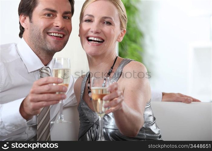 Couple sitting with arms stretched