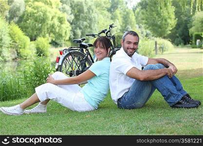 Couple sitting with bicycles