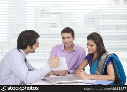 Couple sitting with financial advisor