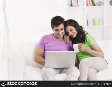 Couple sitting with laptop