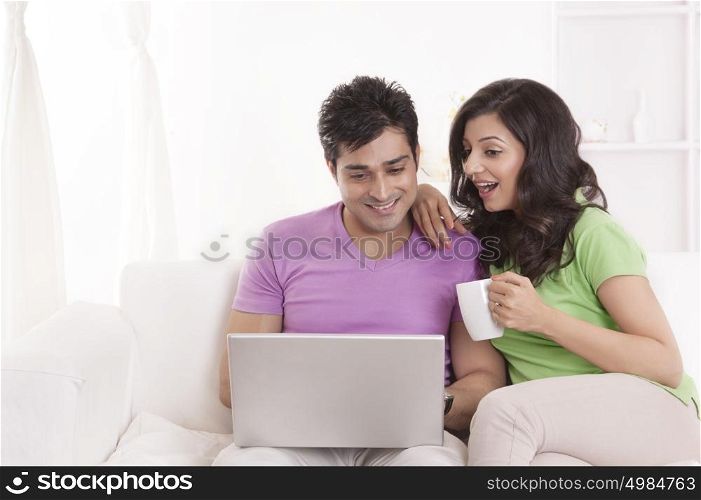 Couple sitting with laptop