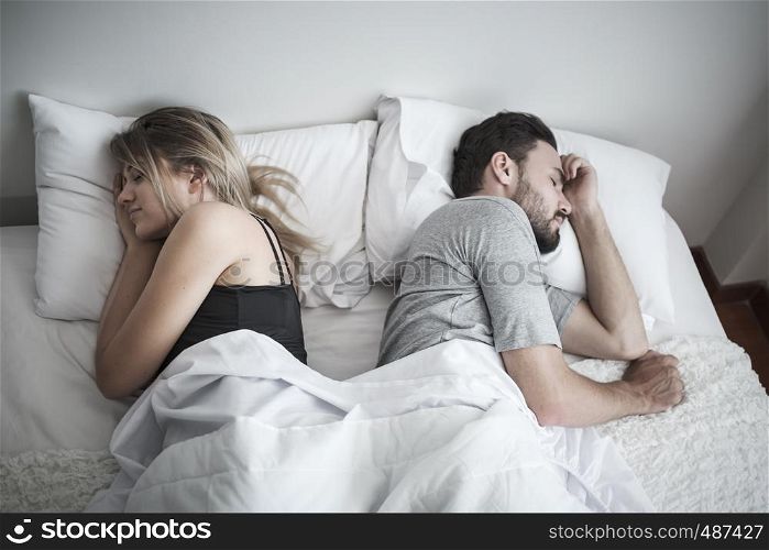 couple sleeping in bed, ignoring each other avoiding sex, having conflict or sexual problems concept