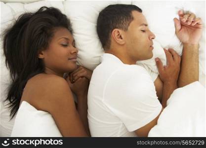 Couple Sleeping In Bed Together