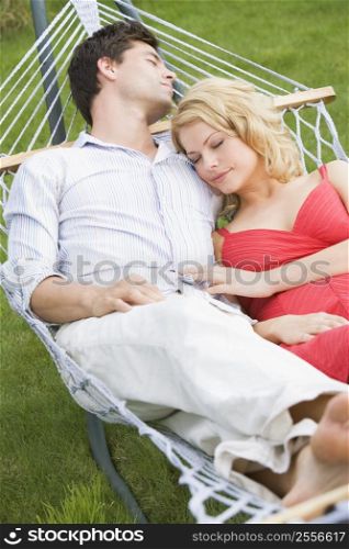 Couple sleeping in hammock