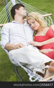 Couple sleeping in hammock
