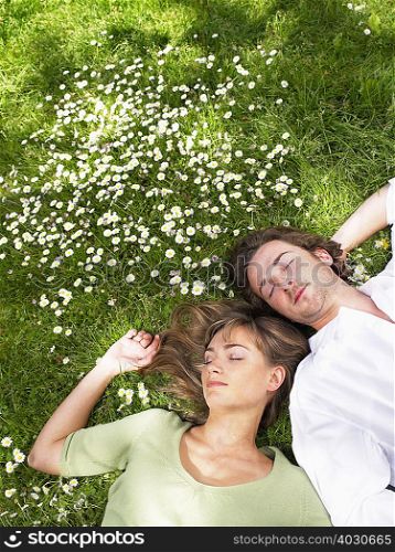 Couple sleeping in the grass