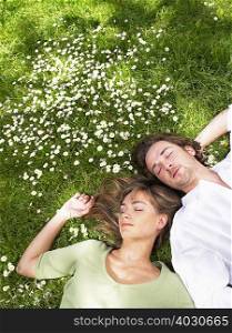 Couple sleeping in the grass