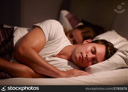 Couple Sleeping Peacefully In Bed Together