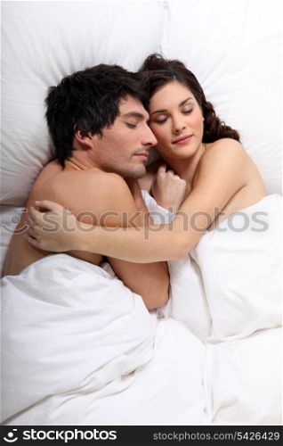 couple sleeping together in bed