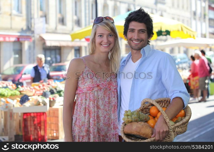 couple smiling blissfully at market