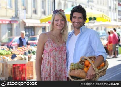 couple smiling blissfully at market