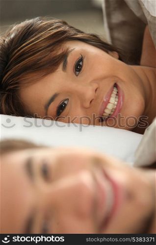 Couple smiling in bed