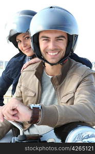 Couple smiling on a motorcycle