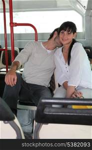 Couple smooching on a bus