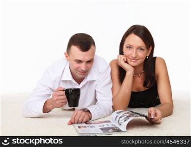 couple spending time together on the floor with a mug
