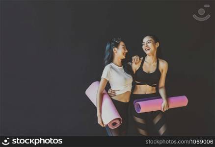 Couple sporty asian woman standing and talking with happiness motion, wearing sportswear bra and pants fashion, posture position, sport club community, sports and healthcare concept