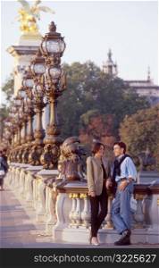 Couple Standing At Ornate Railing