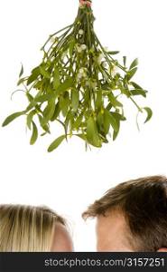 Couple Standing Beneath Mistletoe Against White Background