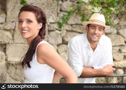 Couple standing by a stone wall