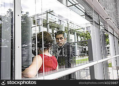 Couple standing by window