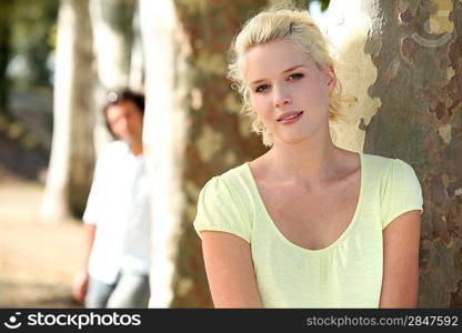 Couple standing in a park by trees