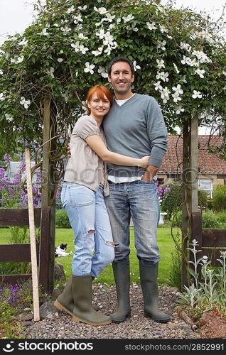 Couple Standing in Front of Home