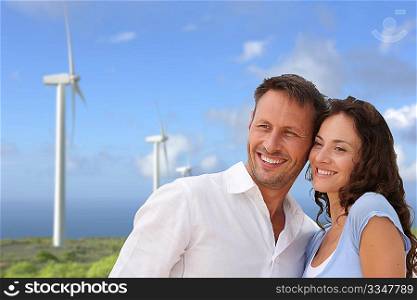 Couple standing in front of wine turbines
