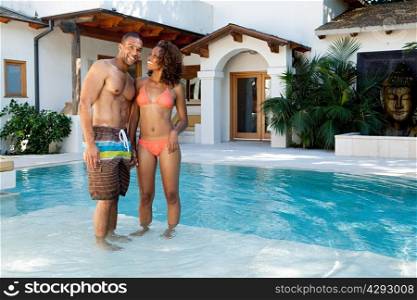 Couple standing in swimming pool