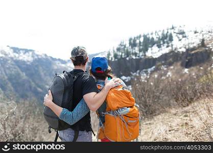 Couple standing, looking at view, rear view, Silver Star Mountain, Washington, USA