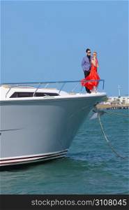 Couple standing on bow of boat