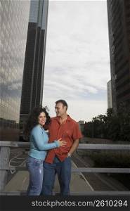 Couple standing on bridge in downtown Los Angeles