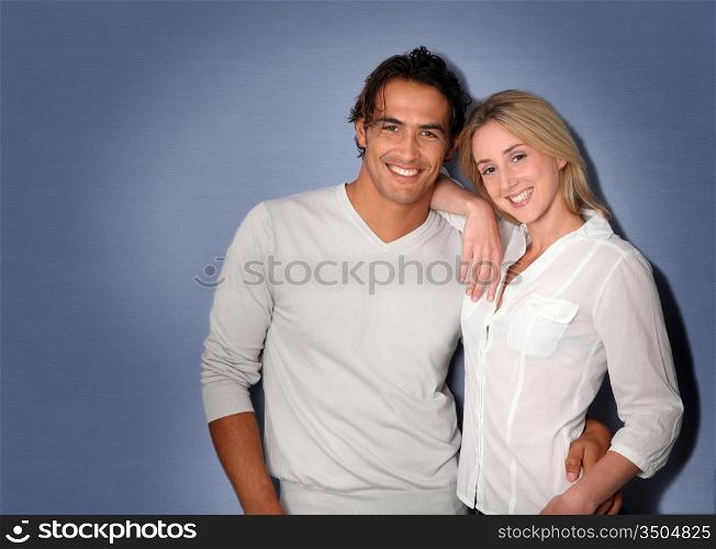 Couple standing on grey background