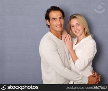 Couple standing on grey background