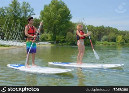 couple standing on paddle board