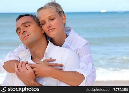 Couple standing on secluded beach
