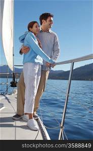 Couple Standing on Side of Sailboat
