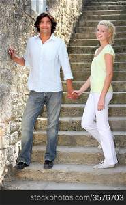Couple standing on some old stone steps