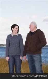 Couple standing on the beach and smiling