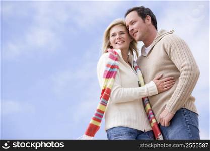 Couple standing outdoors smiling