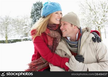 Couple Standing Outside In Snowy Landscape