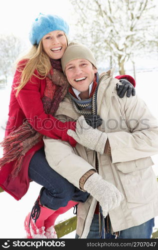 Couple Standing Outside In Snowy Landscape