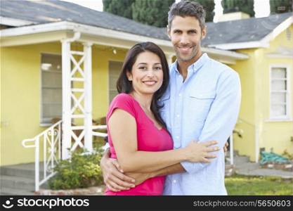 Couple Standing Outside Suburban Home