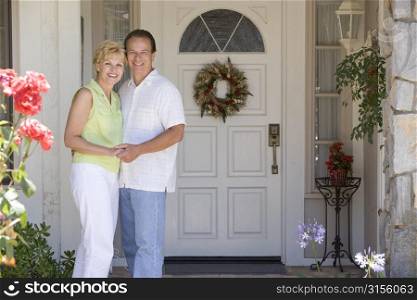 Couple Standing Outside Their House